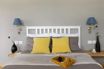 a bedroom with a large bed with yellow pillows at B&B Lupo in Cavareno