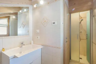 a bedroom with two beds in a wooden cabin at Appartamenti Casa Salesai in Carano