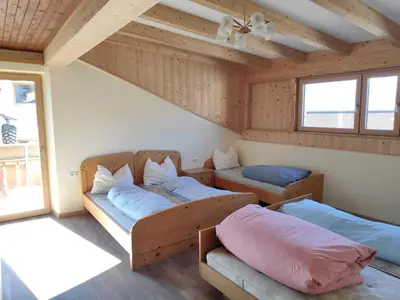 a room with two beds and a couch at Plonerhof - Ferienhaus Maria in Rodengo