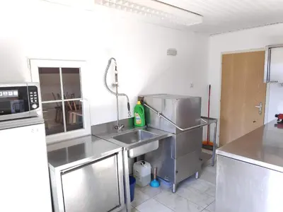 a kitchen with a sink and a microwave at Plonerhof - Ferienhaus Maria in Rodengo