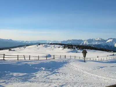 a person walking on a snow covered slope with mountains at Plonerhof - Ferienhaus Maria in Rodengo