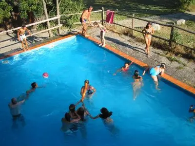 a group of people playing in a swimming pool at Plonerhof - Ferienhaus Maria in Rodengo
