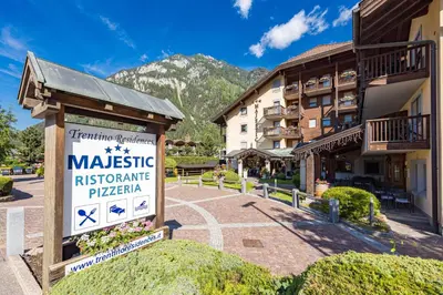 a sign for the masisse historic apartment hotel at Aparthotel Majestic in Predazzo