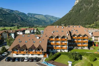 an aerial view of a hotel with mountains in the background at Aparthotel Majestic in Predazzo