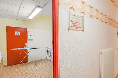 a laundry room with a washer and dryer next to a wall at Aparthotel Majestic in Predazzo