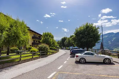 a view of a town with a church and mountains at Residence Lagorai in Tesero