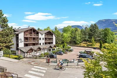 a hotel in the mountains with snow on the ground at Aparthotel Des Alpes in Cavalese
