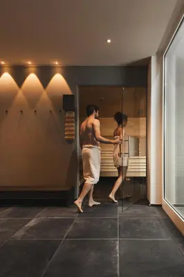 a man standing in front of a mirror in a bathroom at Golserhof in Tirolo