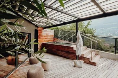 a balcony of a house with a wooden deck at Golserhof in Tirolo