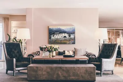 a living room with a coffee table and two chairs at Golserhof in Tirolo