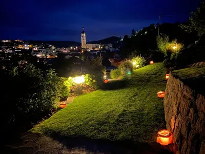 a view of a city at night with lights at Appartements Plattnerhof in Castelrotto
