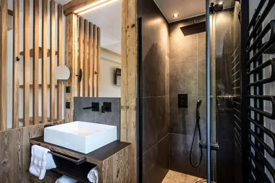 a bathroom with a sink and a shower at Appartements Plattnerhof in Castelrotto