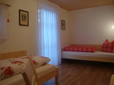 a room with a bed and a window and a couch at Thalerhof in Perca