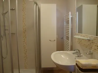a bathroom with a sink and a glass shower at Thalerhof in Perca