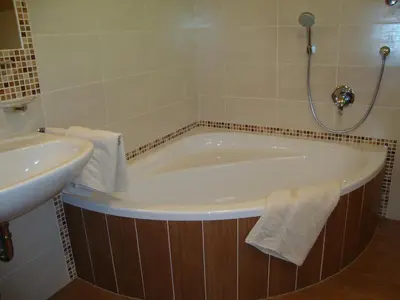 a bath tub and a sink in a bathroom at Thalerhof in Perca