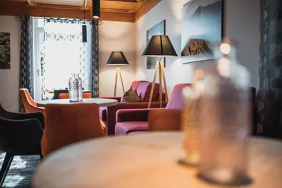 a living room with a couch and a table at Hotel Ludwigshof & Luvina in Trodena