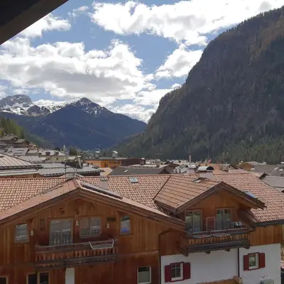 a view of a town with mountains in the background at Col Rodella in Campitello di Fassa