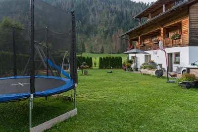 a playground in a yard next to a house at Roderhof in Braies
