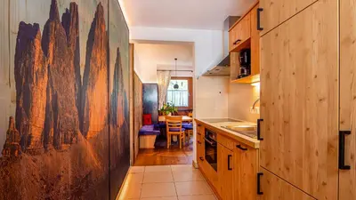 a kitchen with a large painting on the wall at Roderhof in Braies