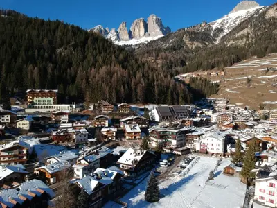 an aerial view of a small village in the mountains at Aliza in Campitello di Fassa