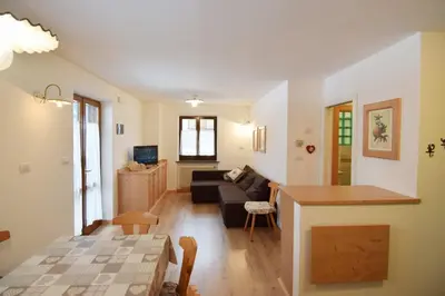 a living room with a couch and a table at Aliza in Campitello di Fassa