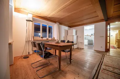 a dining room with a wooden table and chairs at Apartments Stina in Ortisei