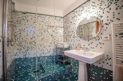 a bathroom with a sink and a shower at Apartments Stina in Ortisei