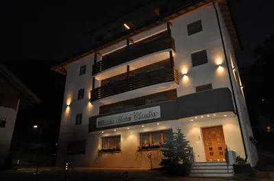 a large white building with a sign on it at Piccolo Hotel Claudia No Pets in San Vigilio Di Marebbe