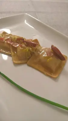 a white plate with two pieces of food on it at Hotel Serenella in Canale San Bovo