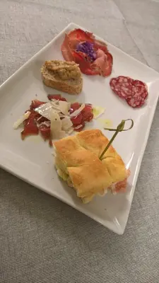 a white plate with food on a table at Hotel Serenella in Canale San Bovo