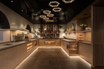 a kitchen with a sink and a counter with lights at Hotel Burggräflerhof in Merano