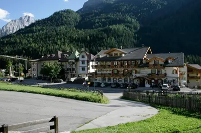 a town in the mountains with a building at Hotel B&B Andreas in Canazei