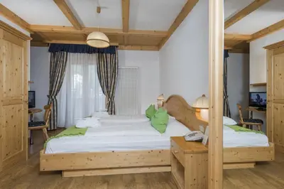 a bedroom with two beds in a room at Hotel B&B Andreas in Canazei