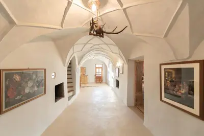 a hallway in a house with a ceiling with a chandelier at Hotel Gassenwirt in Chienes