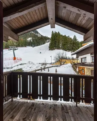 a view from the deck of a ski lodge with snow at Residence Soratru in San Vigilio Di Marebbe