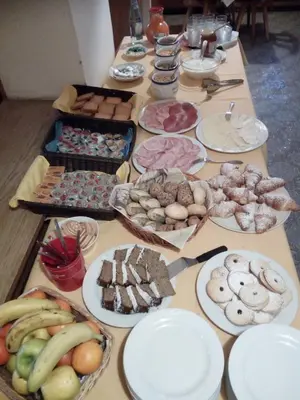 a long table filled with different types of food at Albergo Somont in Ortisei