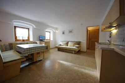a living room with a bed and a couch at Soroea in San Vigilio Di Marebbe