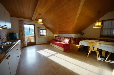 a kitchen and living room with a couch and a table at Soroea in San Vigilio Di Marebbe