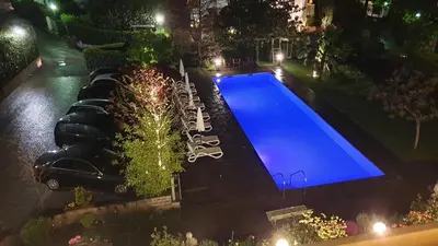 an overhead view of a swimming pool at night at Hotel Tiffany in Merano