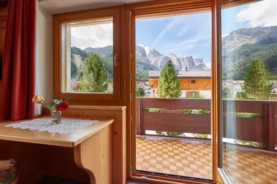 a room with a window with a view of mountains at La Cianò in Corvara in Badia