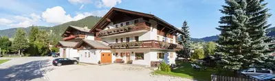 a large house with a car parked in front of it at La Cianò in Corvara in Badia