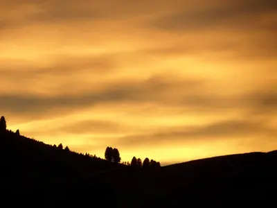 a view of a snow covered mountain with a sunset at Rifugio Fermeda Hutte in Santa Cristina in Val Gardena