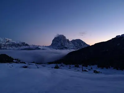 a hot tub in the snow with mountains in the background at Rifugio Fermeda Hutte in Santa Cristina in Val Gardena