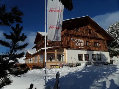 a waiting room with chairs and a table at Rifugio Fermeda Hutte in Santa Cristina in Val Gardena