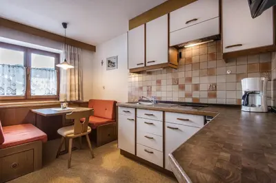 a kitchen with a bowl of fruit on the counter at Garnì Piz da L'Ander in Corvara in Badia
