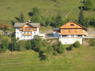 a house on a hill in a field at Leitnerhof in Terento