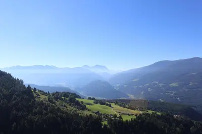 a view of a valley with mountains and a lake at Leitnerhof in Terento