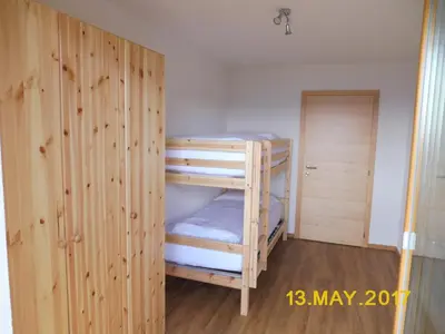 a room with two bunk beds and a closet at Leitnerhof in Terento