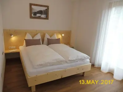 a bed with white sheets and pillows in a bedroom at Leitnerhof in Terento