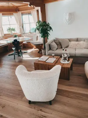 a living room with a couch and a table at Mountain Chalet Pra Ronch in Selva di Val Gardena